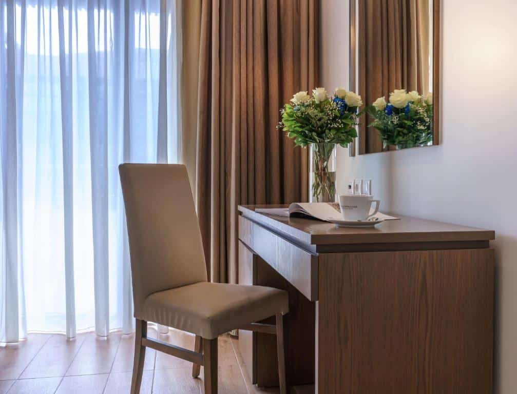 Pool with a deck chair with a woman sitting on it 