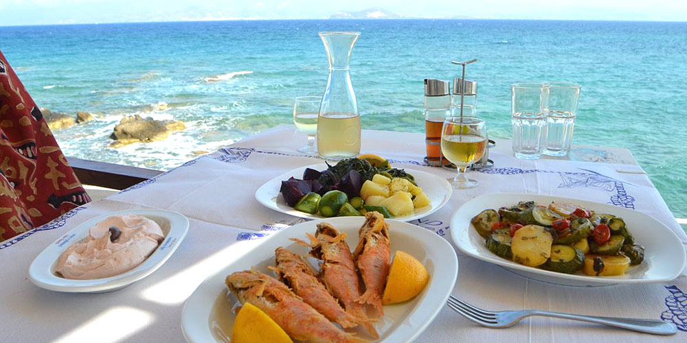 Food table in front of the sea.