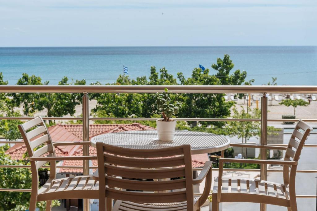 Balcony with a table, chairs and sea view