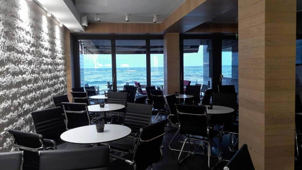 Bath tub and deck chair in front of the sea