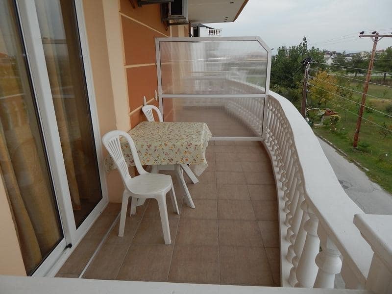 Balcony with a table, chairs and sea view