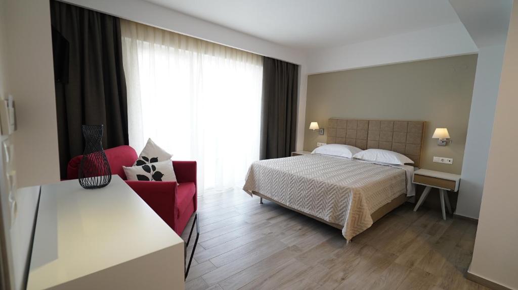 Room with one double bed, a chair and a desk